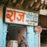 Indian entrepreneur smiling in small business shop